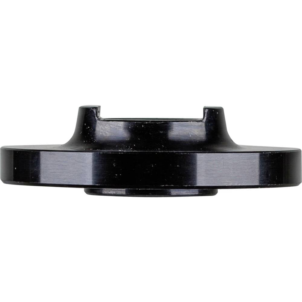 Boîtier métallique noir de forme circulaire avec partie centrale surélevée, adapté aux applications techniques ou à la construction mécanique.