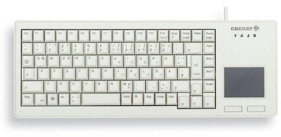 Clavier d'ordinateur blanc avec pavé tactile intégré sur le côté droit, connexion par câble en haut à droite, logo Cherry en haut à droite.