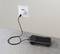 Un appareil électronique portable est en charge via un câble USB branché à une prise murale.