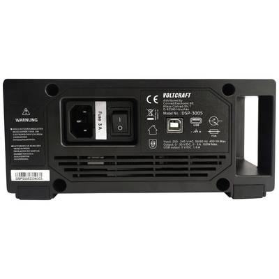 'Voltcraft DSP-3005', une alimentation. La vue arrière montre le bouton marche/arrêt, le fusible, la plaque signalétique et un message d'avertissement en allemand.