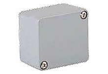 Boîtier rectangulaire gris avec deux vis aux coins opposés, probablement destiné à la protection ou à des applications électriques.