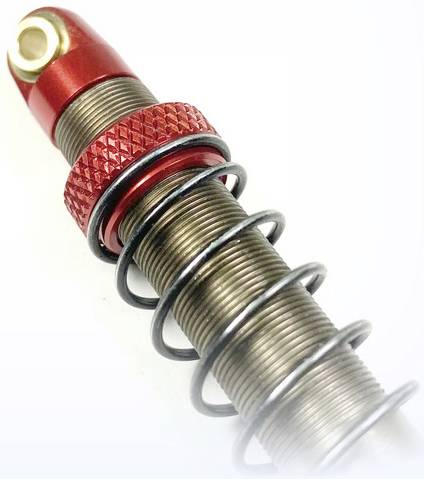 Amortisseur rouge avec ressort métallique, partiellement fabriqué en aluminium et en acier, adapté aux applications techniques.