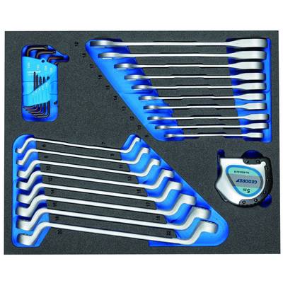 Une boîte à outils contenant différentes clés et un mètre ruban. Les outils sont soigneusement rangés dans une mousse de protection.