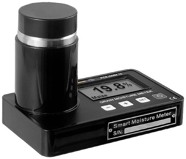 Dispositif noir et gris de mesure de l'humidité des céréales posé sur une table, affichant '19,8%' et 'Smart Moisture Meter', avec des boutons de contrôle.