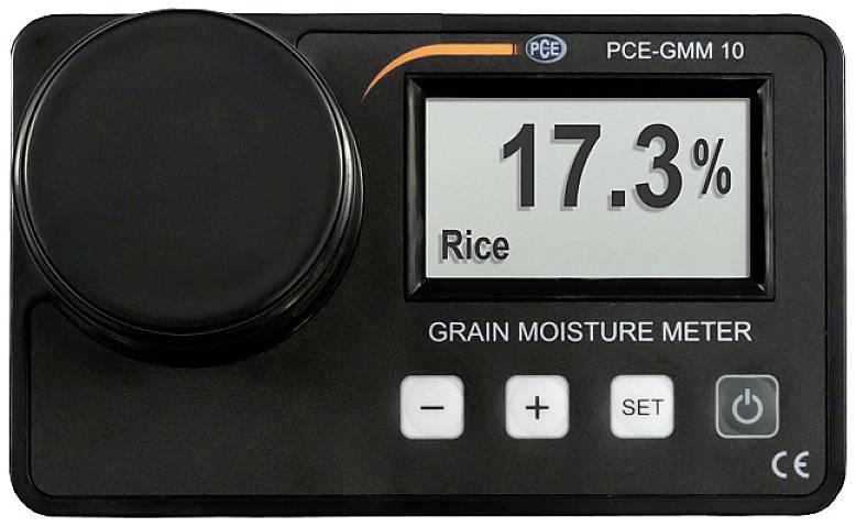 Un appareil de mesure d'humidité indique 17,3 % pour le riz. Il est doté de touches de commande et d'un affichage numérique.