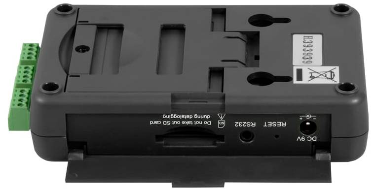Module de contrôle électronique noir avec bornes de vis vertes, connecteur d'alimentation CC 9V, bouton de réinitialisation et trous de montage présentés sur un fond blanc.