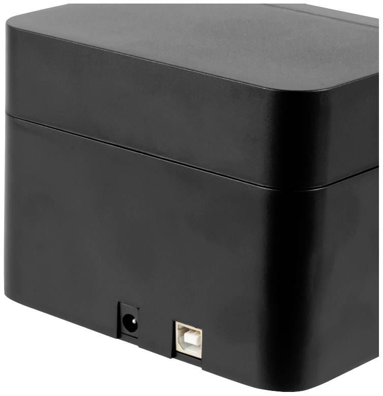 L'image montre un appareil électronique noir rectangulaire avec des ports sur sa face inférieure.
