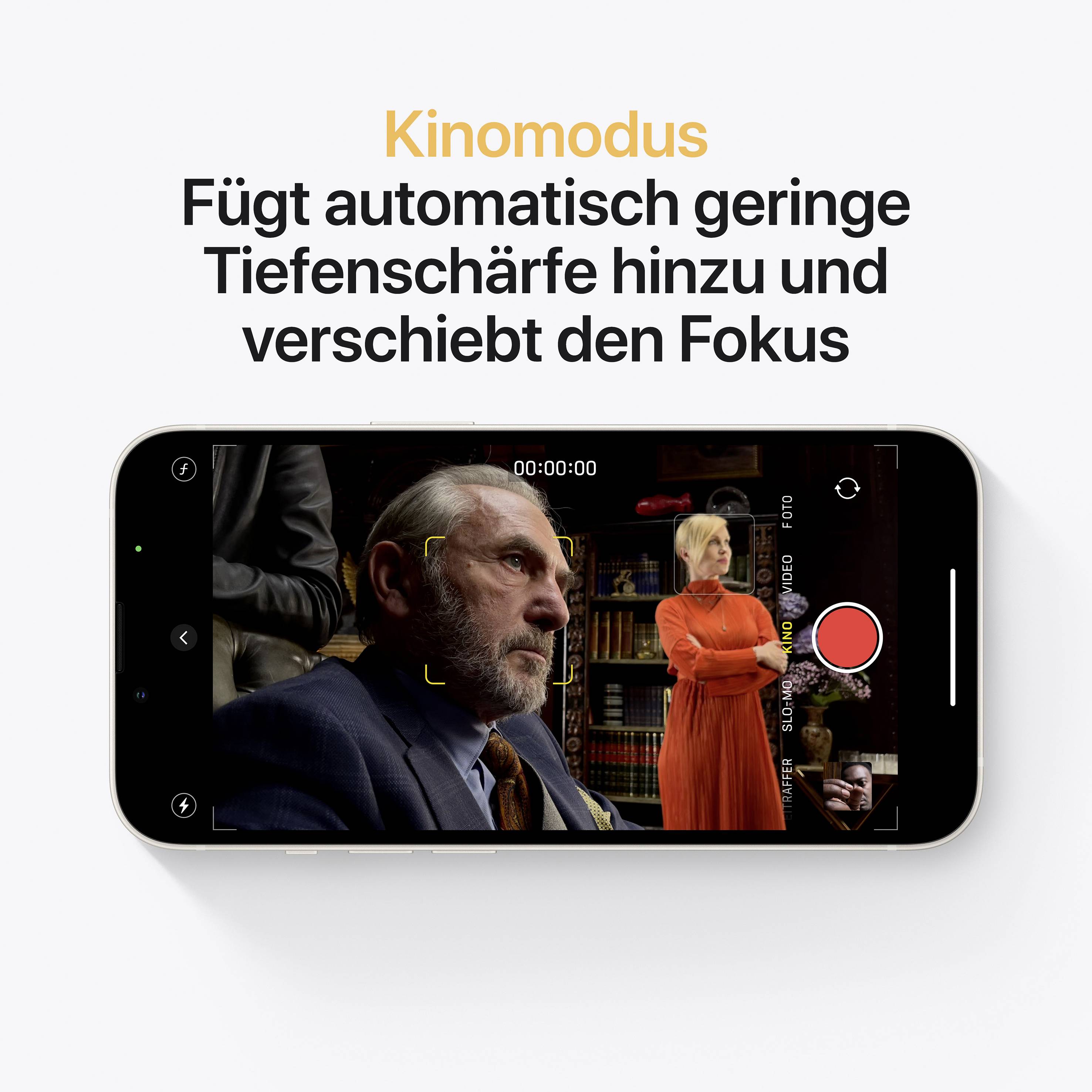 « Kinomodus » s'affiche. Un homme en costume est assis de profil, une femme en robe rouge se tient en arrière-plan. Icône de capture vidéo sur un smartphone.