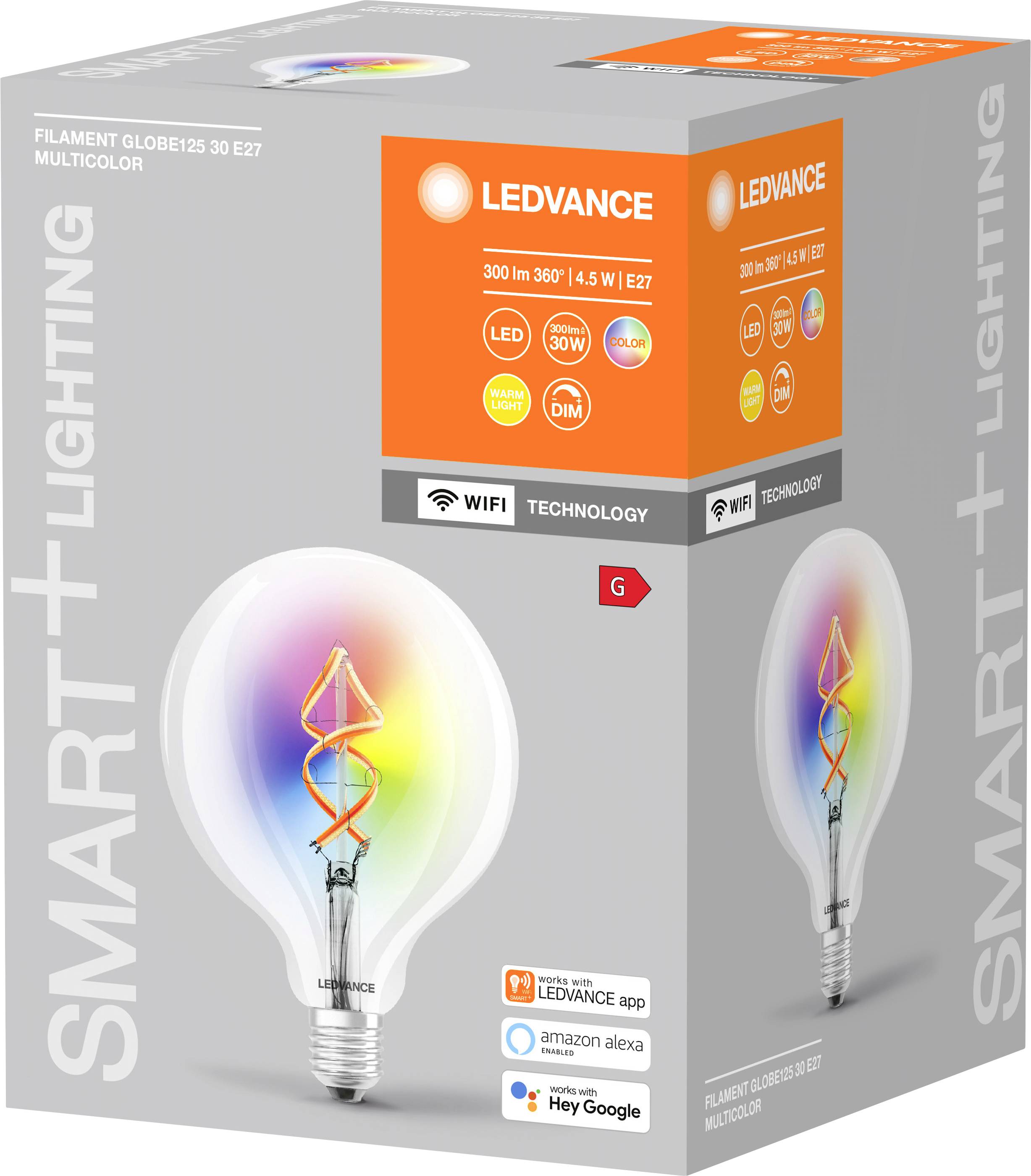 Une ampoule LED dans un carton portant l'inscription 'SMART+ LIGHTING'. Elle présente un filament coloré et est compatible avec le contrôle vocal.