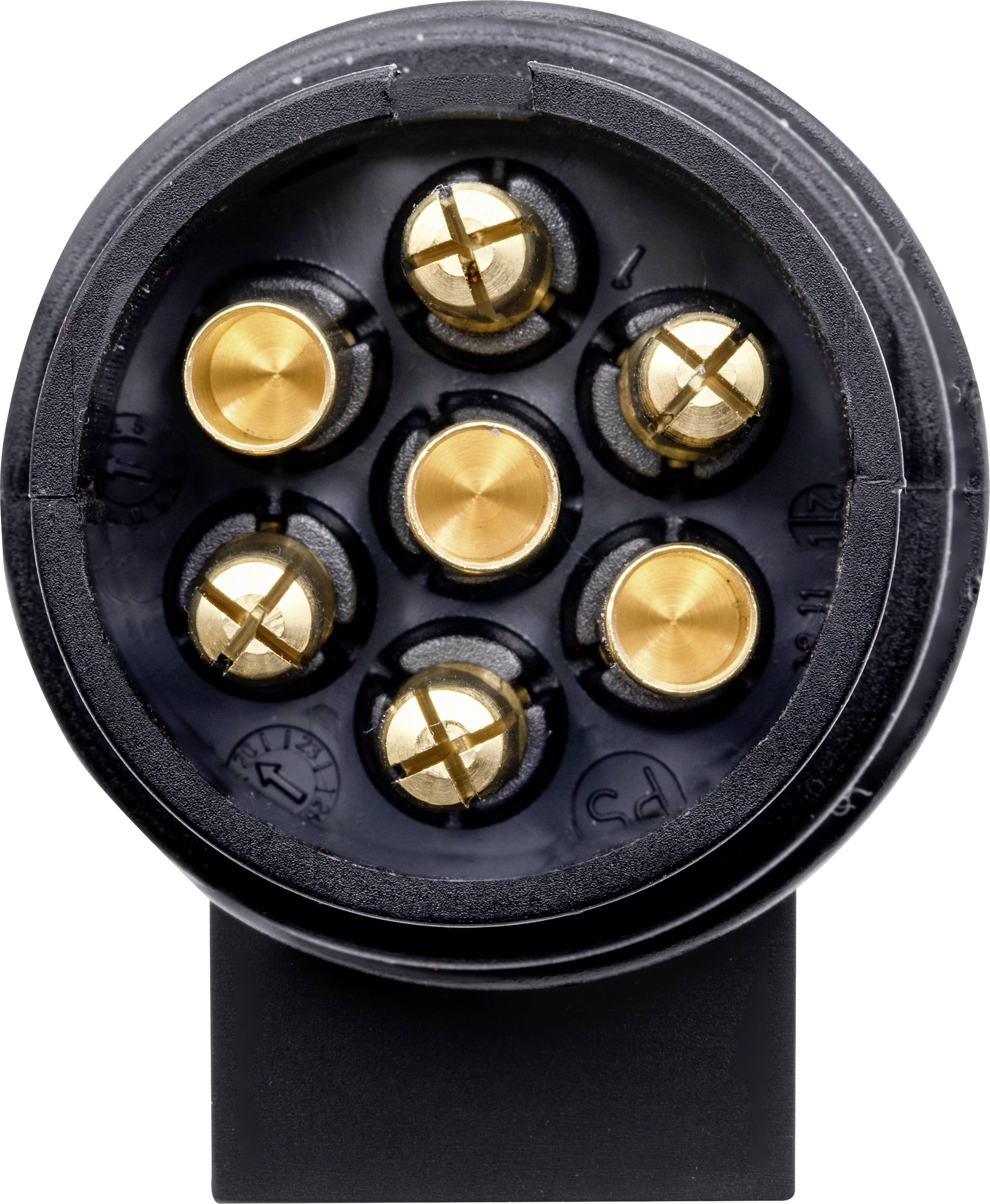 Gros plan d'une prise circulaire à sept contacts dorés sur un fond noir. La prise est destinée à établir une connexion électrique.