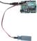 Une carte Arduino avec un capteur d'humidité connecté. La carte est reliée à une source d'alimentation via un câble USB.
