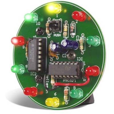 Une carte de circuit imprimé ronde verte avec plusieurs LED rouges, vertes et jaunes, ainsi que deux circuits intégrés.