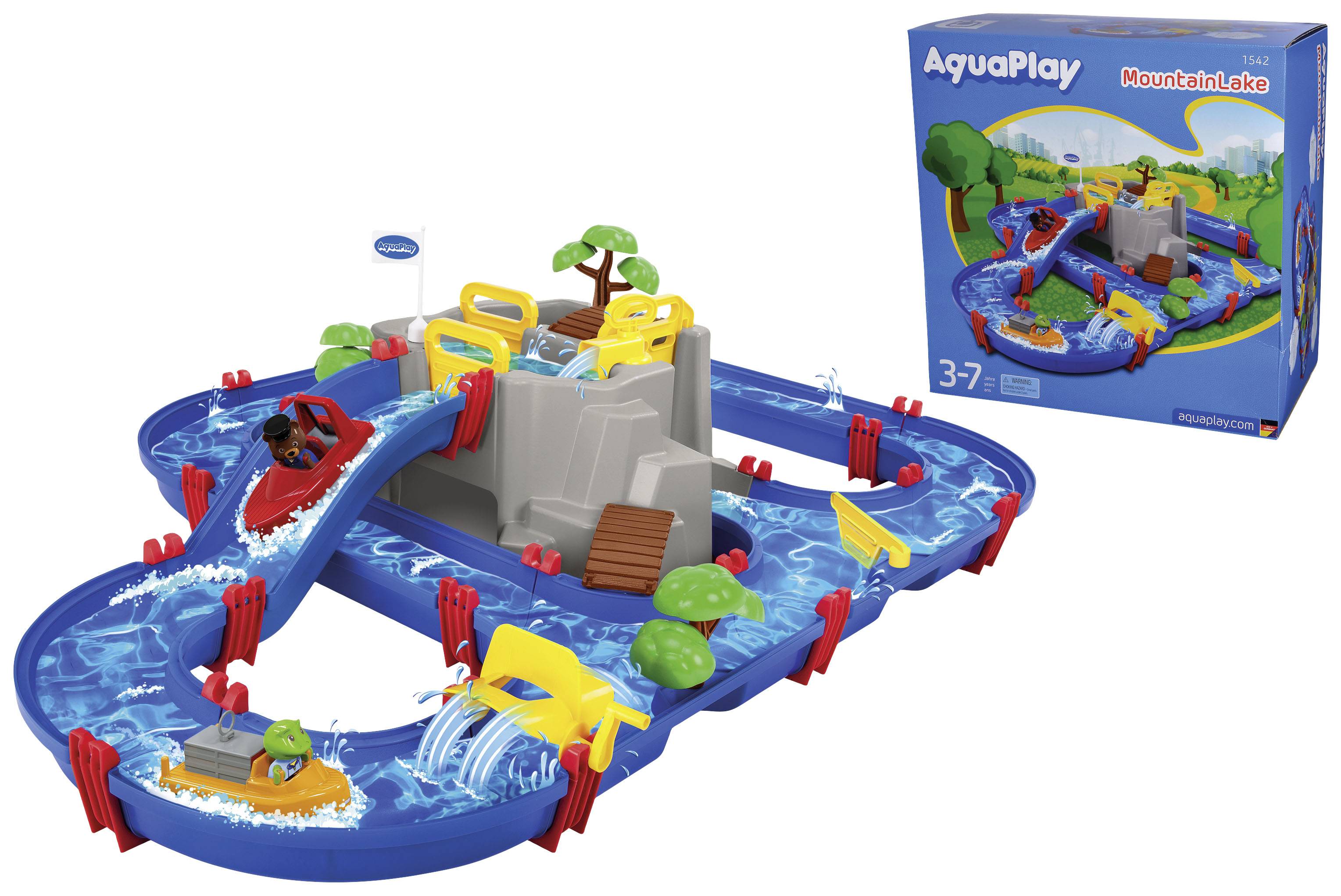 Coffret de jeu 'AquaPlay MountainLake' montrant un circuit aquatique avec des écluses, un bateau et un pont. Emballage à gauche en arrière-plan. Pour enfants de 3 à 7 ans.