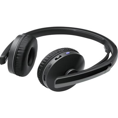 Casque noir sans fil supra-auriculaire avec commandes intégrées et un voyant LED bleu, posé sur une surface.