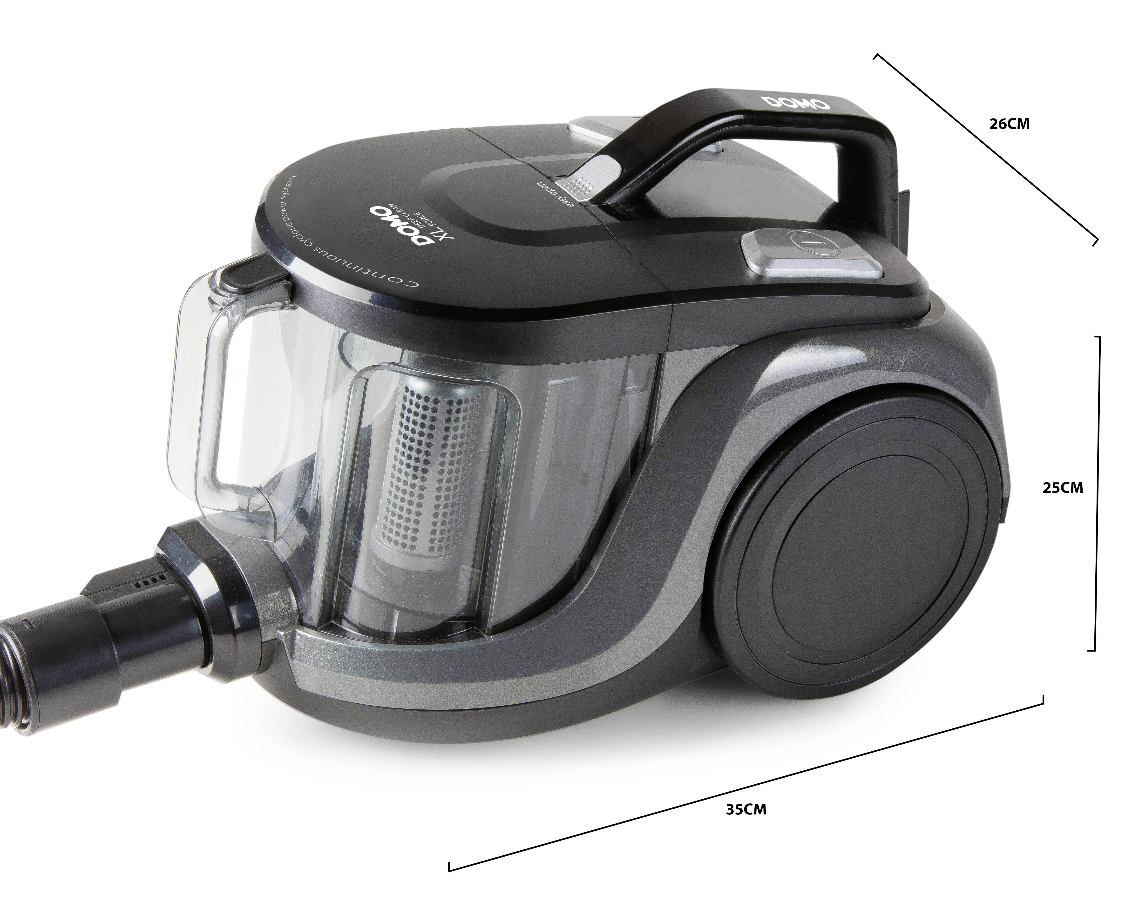 Aspirateur de type cylindrique, avec poignée noire, de forme compacte. Dimensions : 26 cm (hauteur), 25 cm (largeur), 35 cm (longueur).