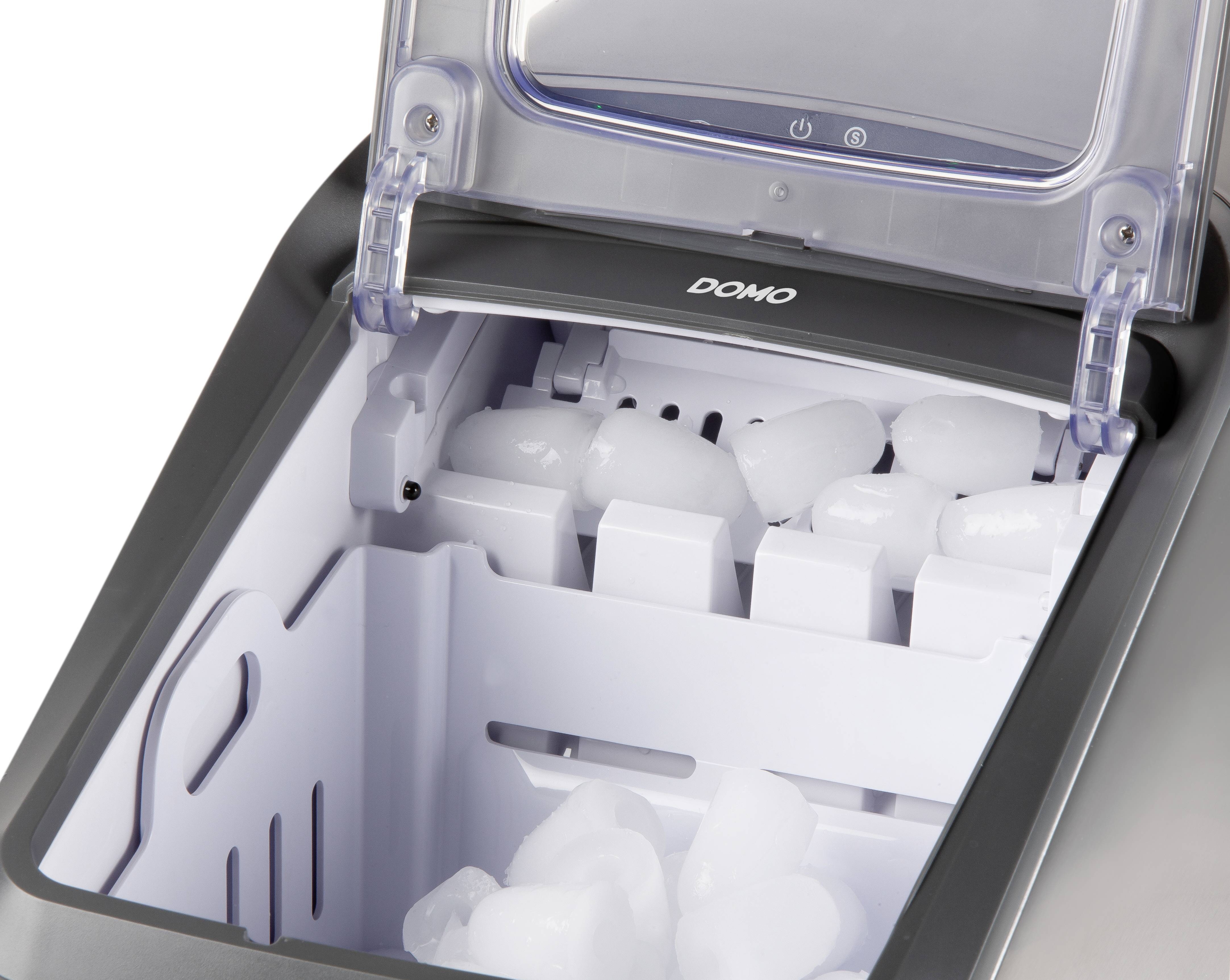 Une machine à glaçons avec le couvercle ouvert, montrant quelques glaçons à l'intérieur.