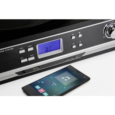 Un smartphone lit de la musique sur une chaîne stéréo. La chaîne stéréo avec un affichage LED bleu indique 'bt' pour la connexion Bluetooth.