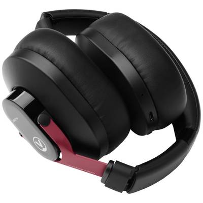 Casque audio circumaural fermé, noir et rouge, avec des coussinets d'oreille rembourrés et un design élégant, présenté de profil.