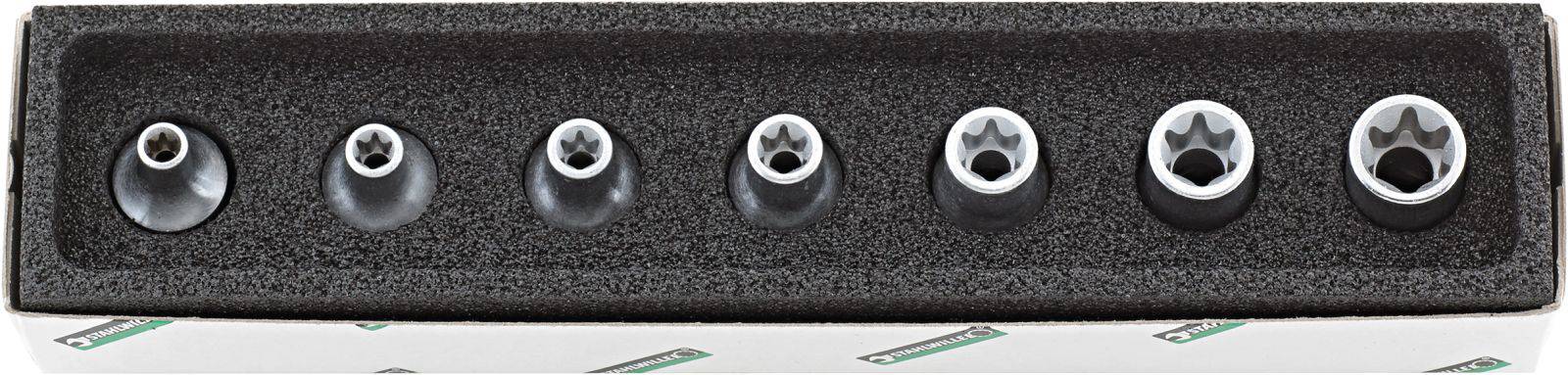 Jeu de sept douilles Torx sur support en mousse. Disposition horizontale du plus petit au plus grand. Kit d'outils standard, couramment utilisé dans les métiers artisanaux.