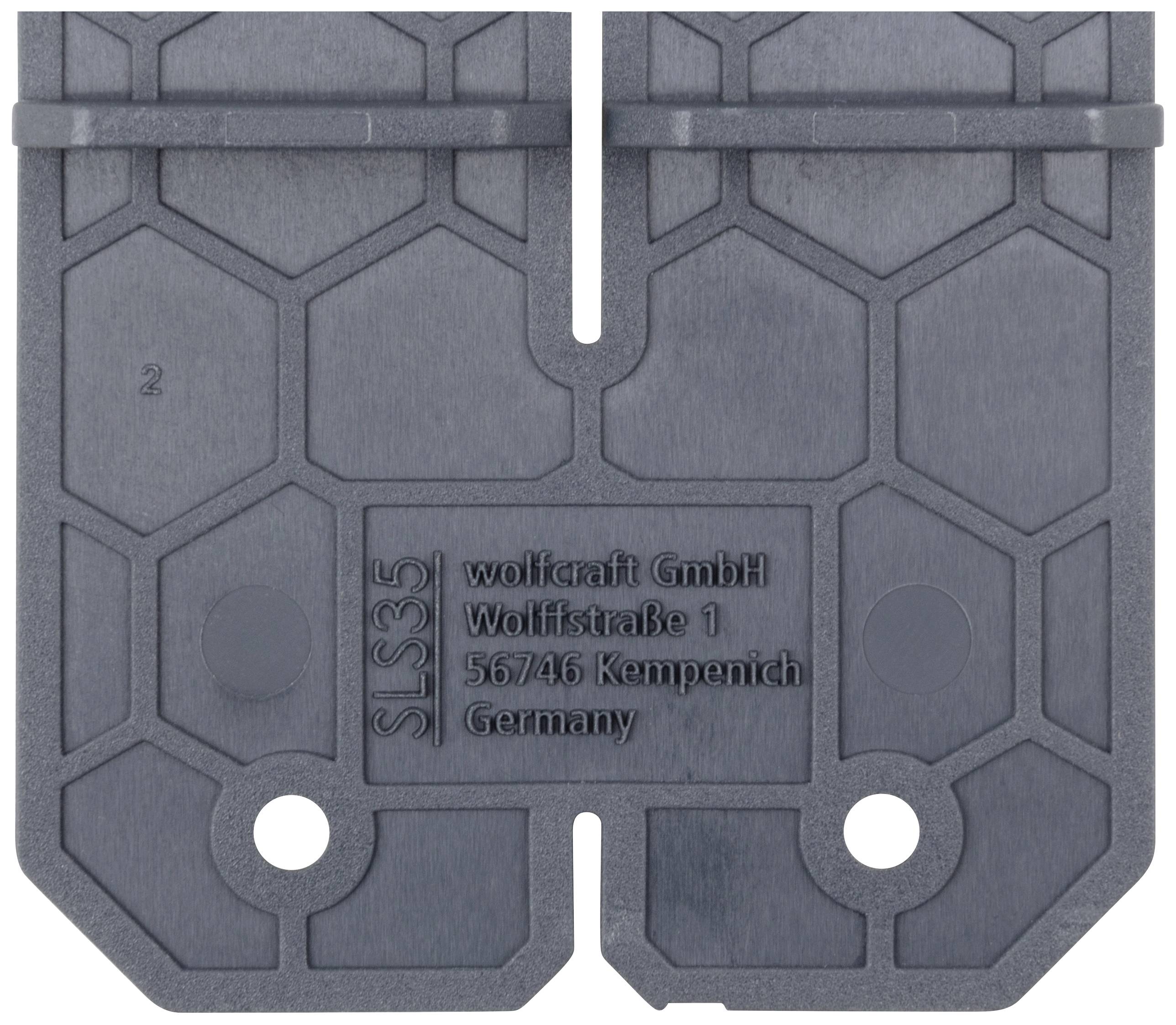 Plaque grise en plastique avec motif hexagonal et inscription 'wolfcraft GmbH Wolfstraße 1 56746 Kempenich Allemagne'.