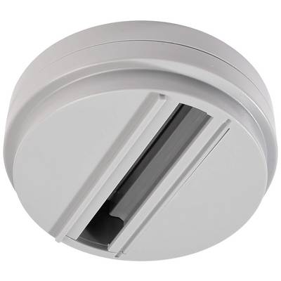 Détecteur de fumée rond et blanc monté au plafond.