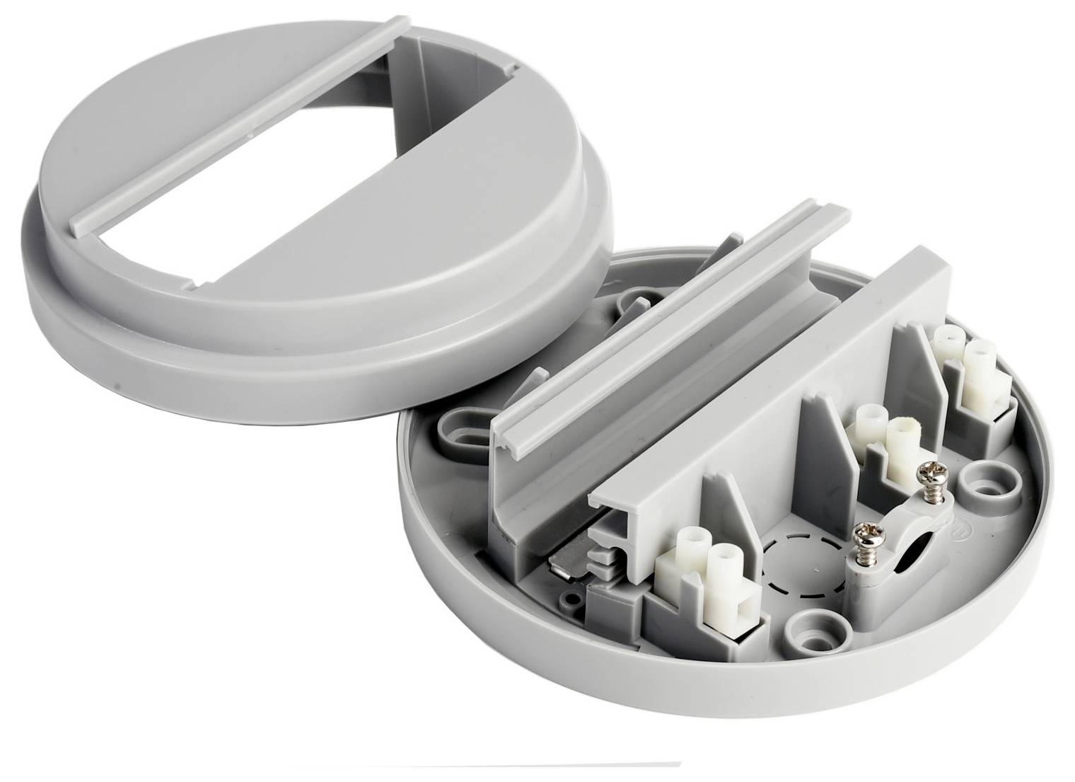 Boîte de jonction électrique ronde en plastique gris, ouverte, avec couvercle articulé, présentée partiellement assemblée et laissant voir les bornes de câblage internes ainsi que les points d'entrée des câbles.