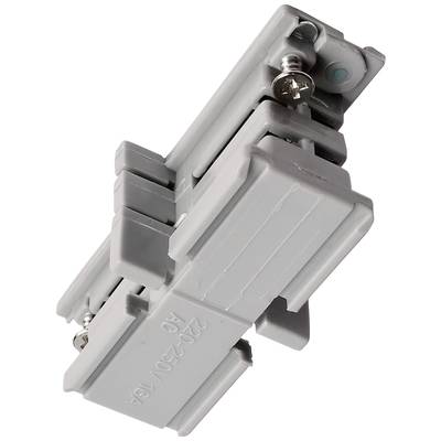 Un élément électrique gris, probablement un adaptateur de montage ou un connecteur, avec des vis visibles pour la fixation.