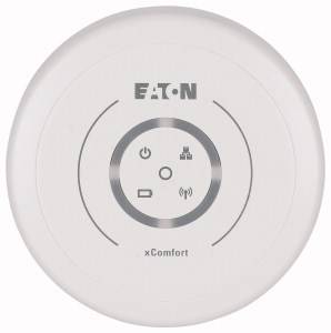 Boîtier de commande de la marque Eaton portant l'inscription 'xComfort', affichant des symboles pour l'électricité, la force du signal et la connexion réseau.