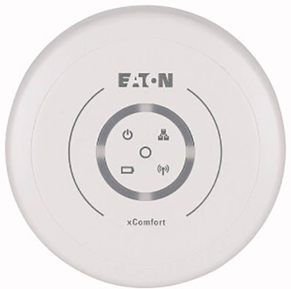Un capteur blanc et rond xComfort d'EATON pour la domotique intelligente, avec des symboles indiquant l'alimentation électrique, le réseau, le signal et l'état de la batterie.