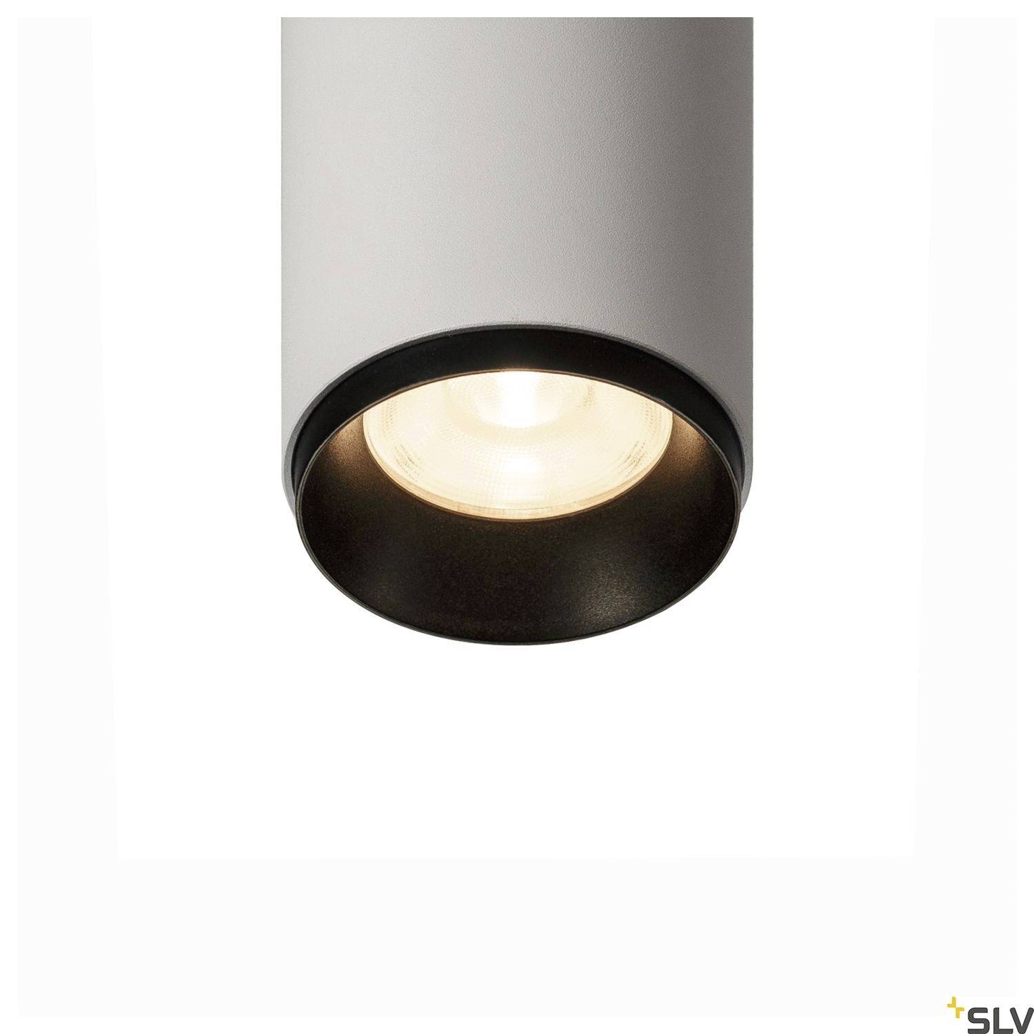 Un luminaire cylindrique au design moderne avec un élément lumineux central diffusant une lumière chaude.
