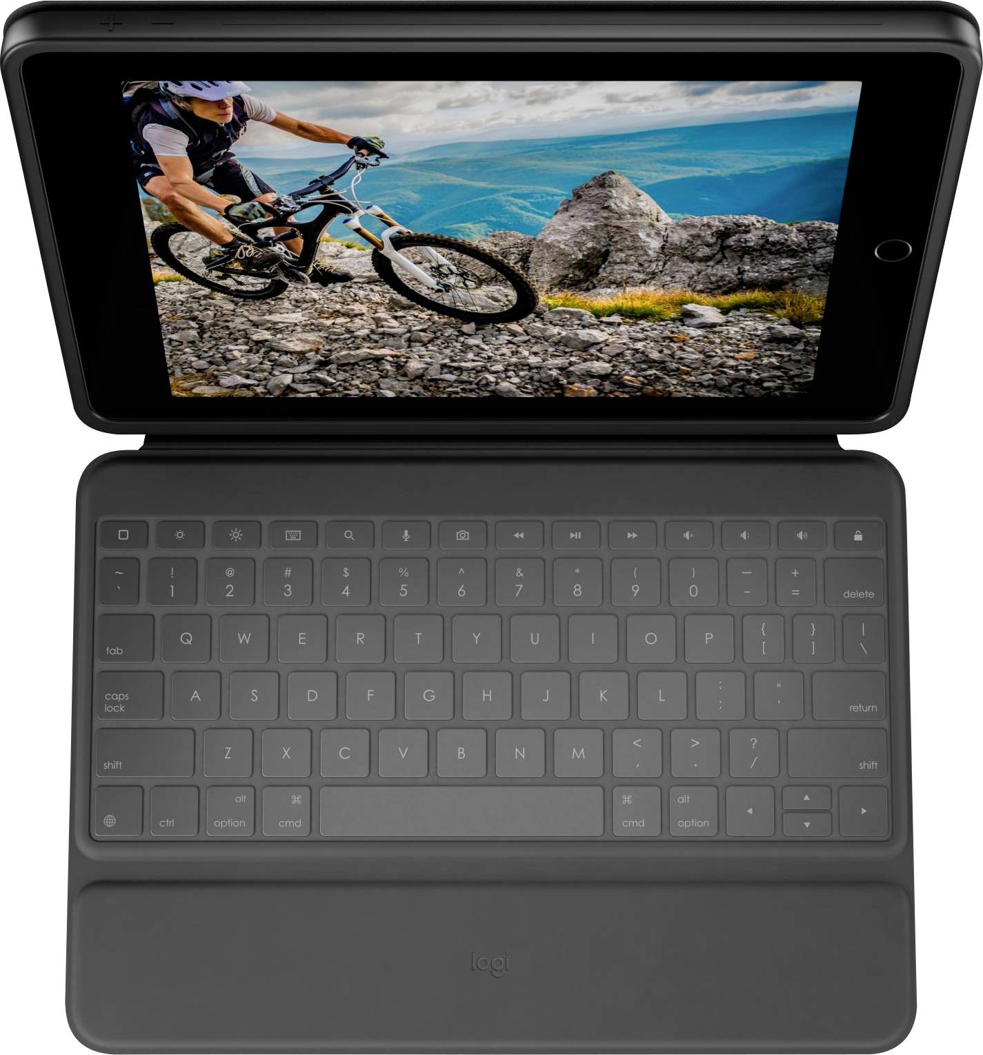 Une tablette avec clavier montre un vététiste roulant sur un sentier rocailleux dans un paysage montagneux.