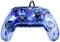 Une manette de jeu transparente bleue avec des lumières LED illuminées, deux sticks analogiques, un pad directionnel et des boutons d'action.