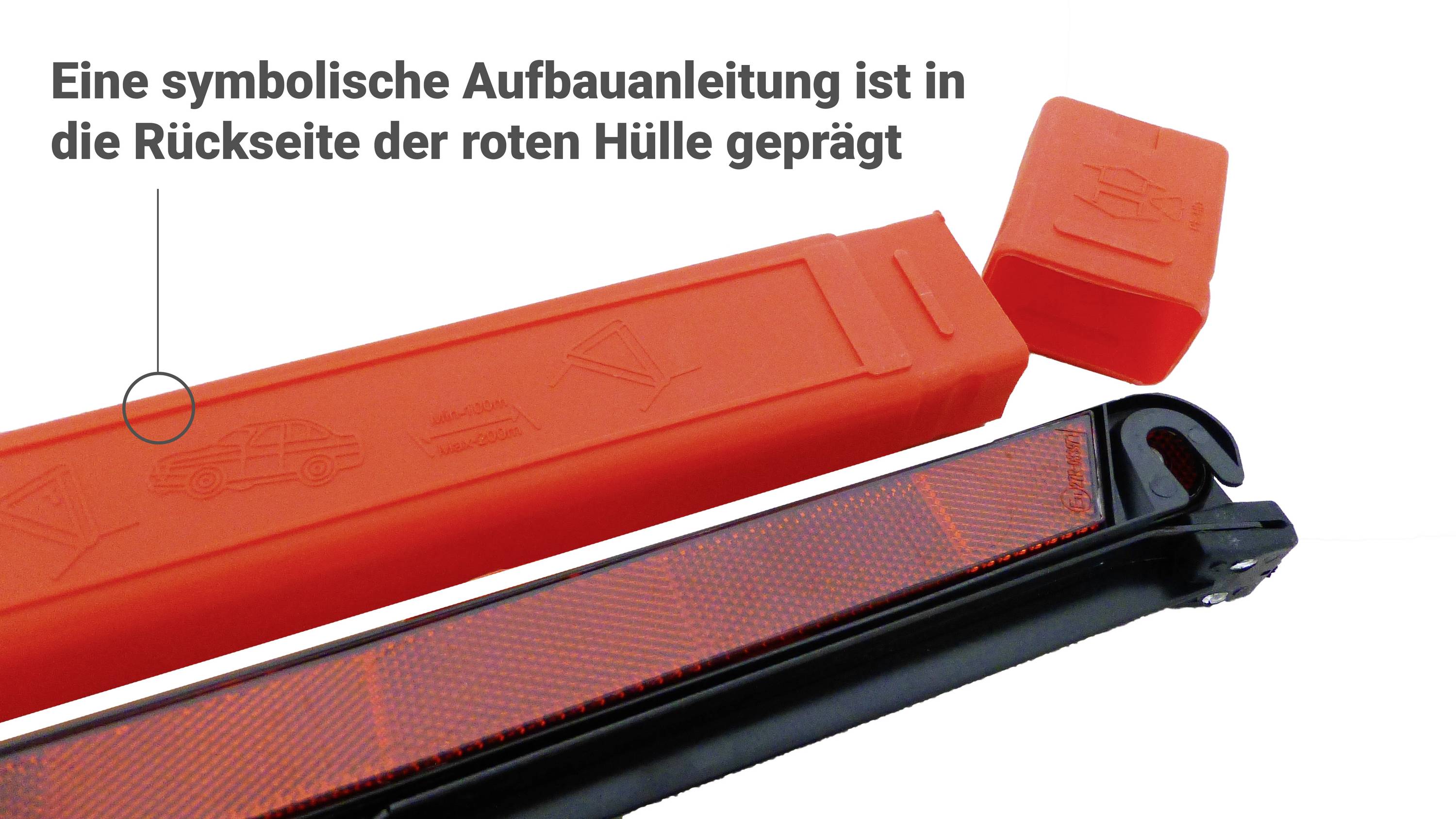 Enveloppe rouge avec instructions de montage embossées, à côté une pièce noire et une autre pièce rouge. En haut, texte 'Une instruction de montage symbolique...'