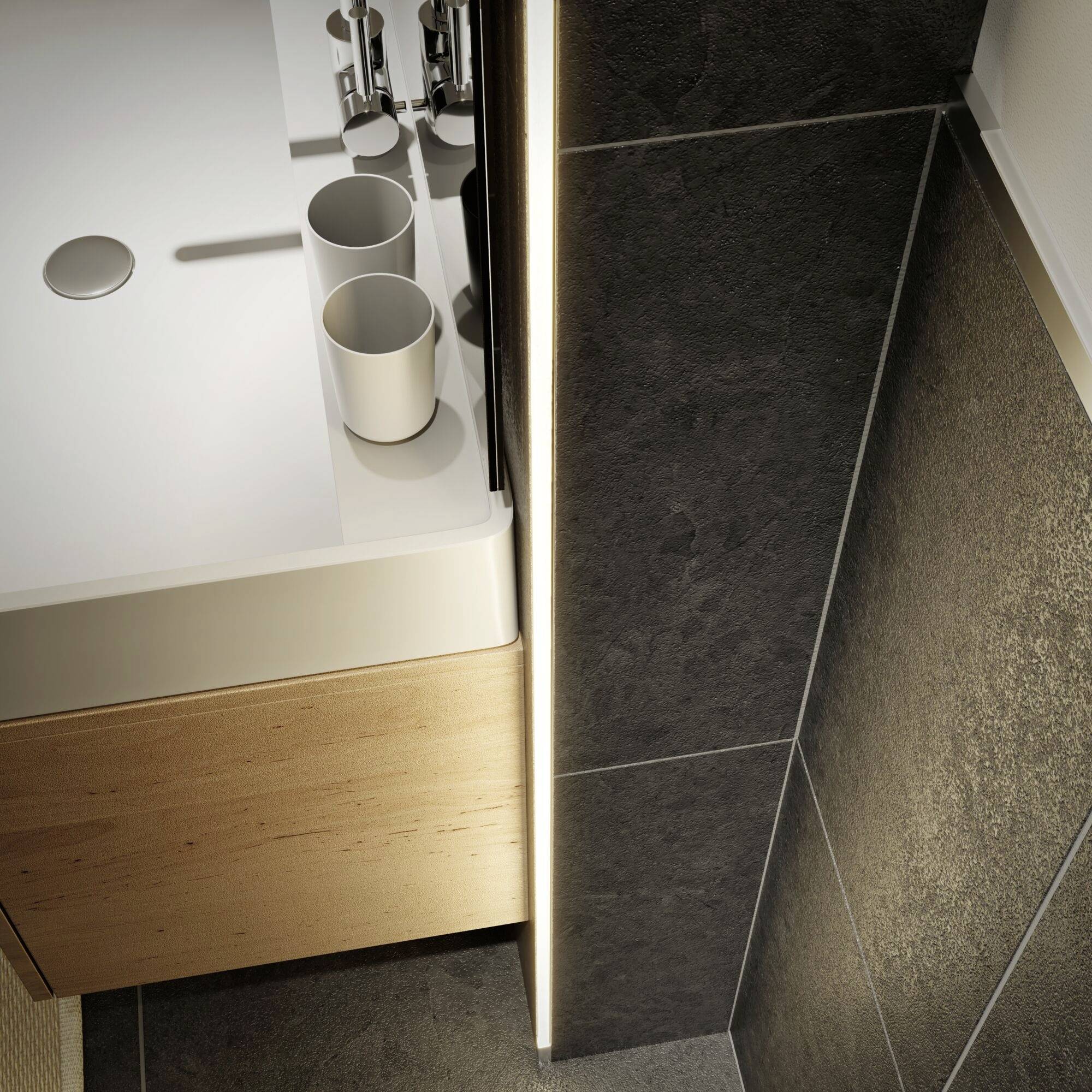 Lavabo en céramique blanche avec deux gobelets à dent vides, entouré de meubles en bois et de carrelage sombre.