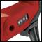 Gros plan d'un boîtier rouge avec un interrupteur noir et des symboles de courant et de résistance, faisant partie d'un outil électrique.