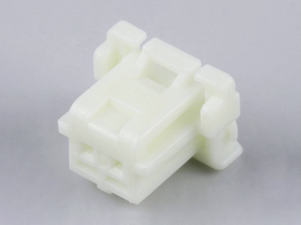 Connecteur en plastique blanc, rectangulaire, avec clips latéraux, sur fond gris.