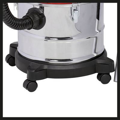 Aspirateur avec un réservoir cylindrique métallique monté sur roulettes, un tuyau noir sur le côté et une base noire à la base.