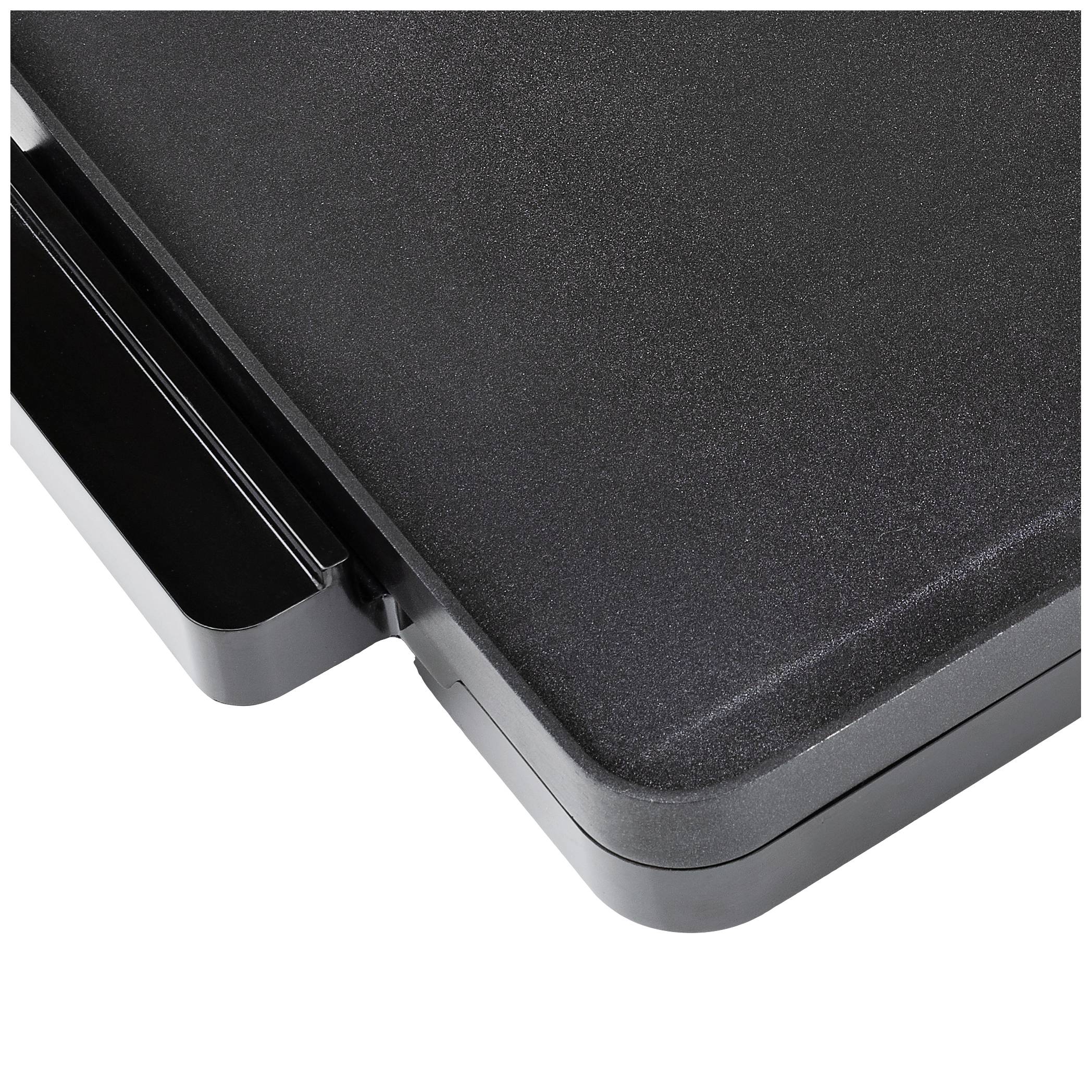 Bord noir d'un objet plat et rectangulaire, probablement une table ou un plan de travail, avec des coins arrondis.