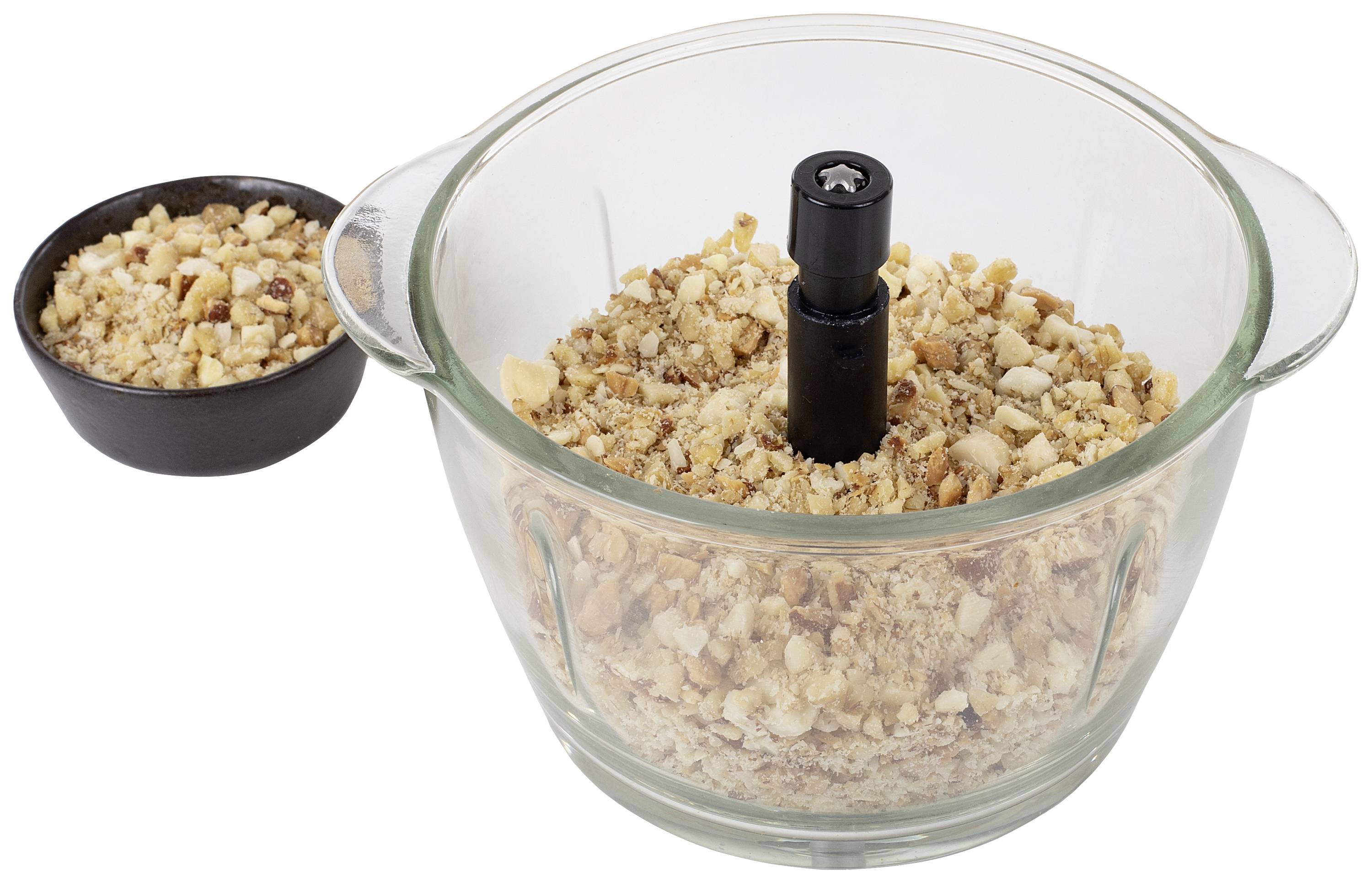 Des noix concassées dans un bol en verre avec une poignée en plastique noir au centre, à côté duquel se trouve un petit bol contenant d'autres noix.