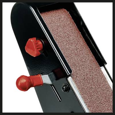 Un outil noir avec une surface de ponçage rouge-brun, deux boutons rouges sur le côté ; probablement un appareil de ponçage.
