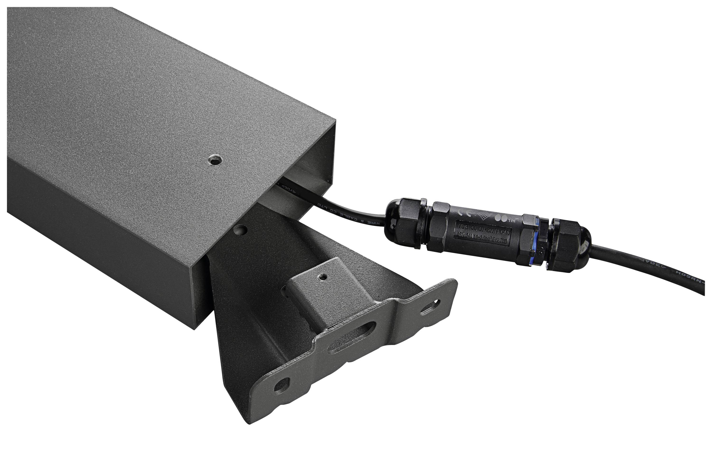 Appareil technique noir avec câble et connexion, probablement un composant d'un système industriel ou électronique.