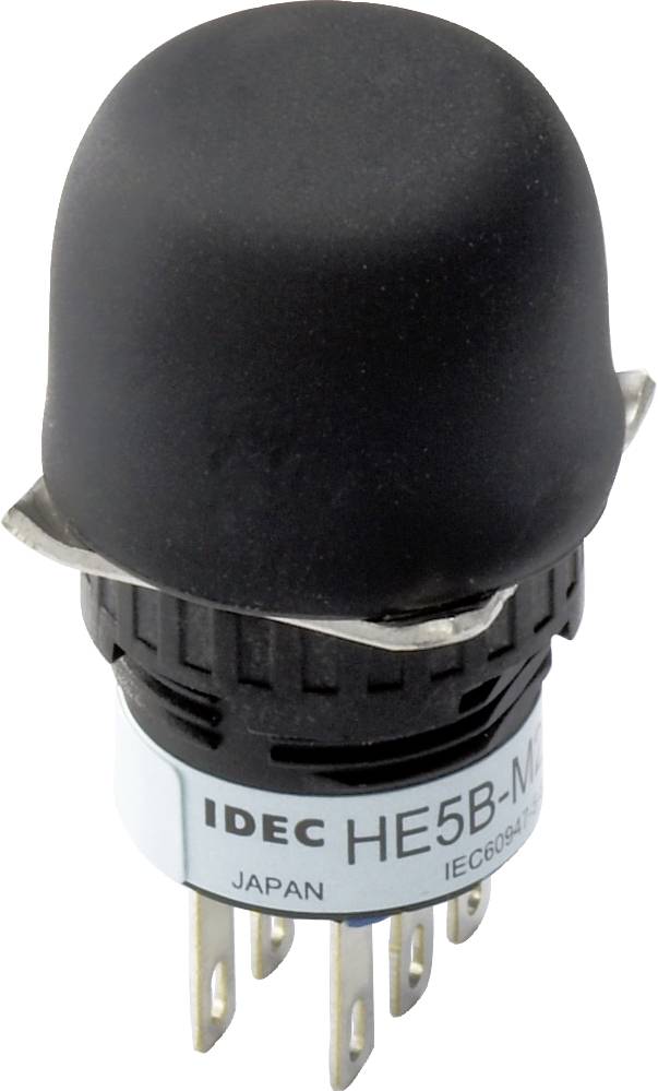 Un bouton-poussoir noir de IDEC avec l'inscription 'HE5B'. En dessous, on peut lire 'JAPAN' et 'IEC60947'. Le bouton possède six broches métalliques.