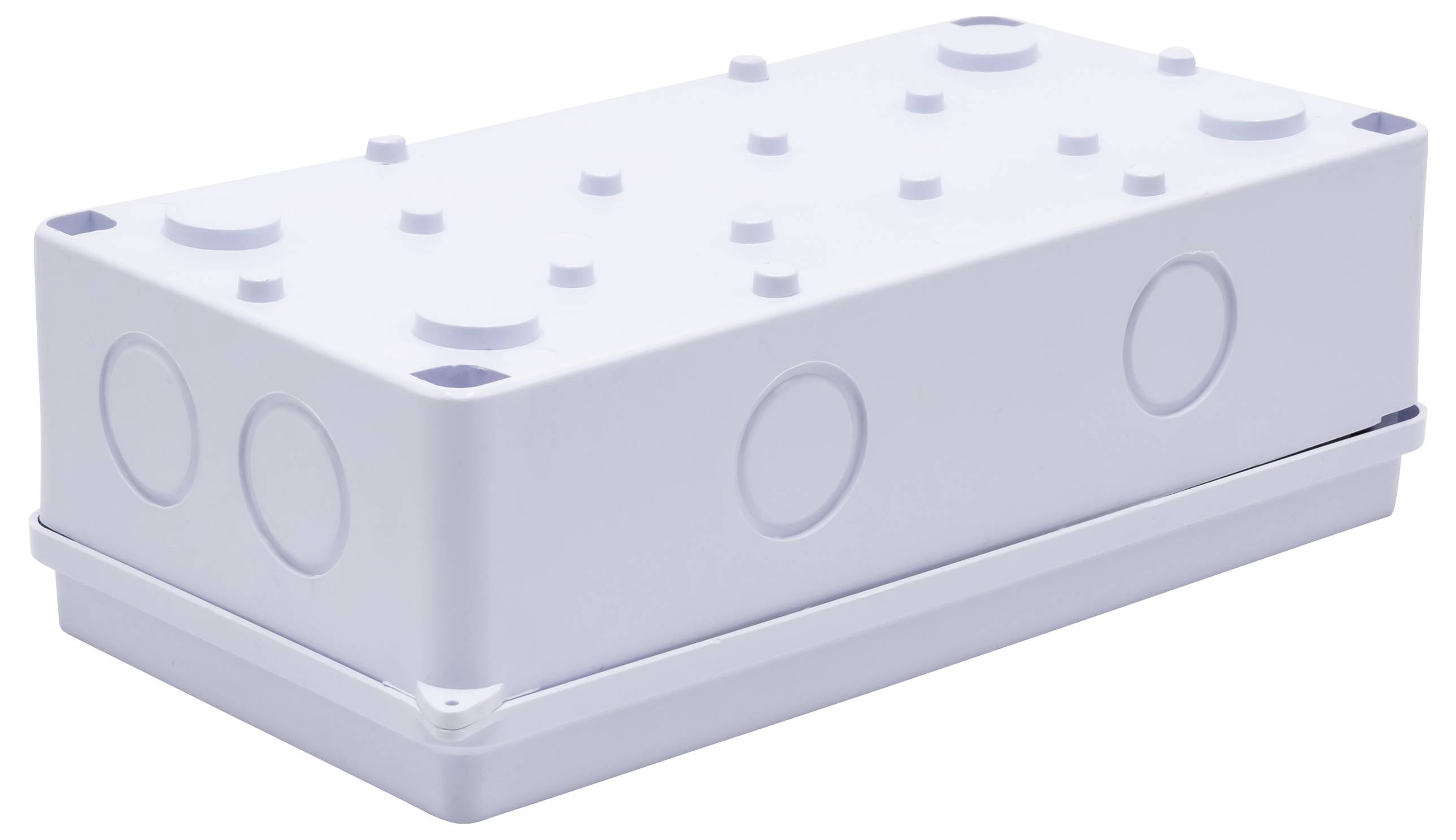 Boîte en plastique blanc avec des motifs en relief circulaires sur les surfaces, probablement un boîtier de connexion électrique.