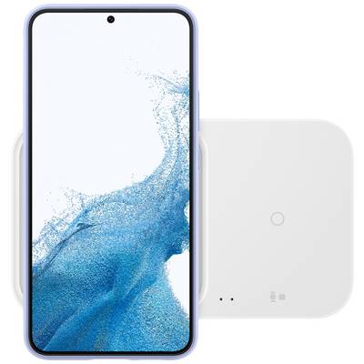 Un smartphone moderne avec un arrière-plan d'écran bleu est posé sur un chargeur sans fil blanc rectangulaire.