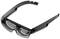 Lunettes à monture noire et verres transparents, ayant un aspect futuriste ou technologique.