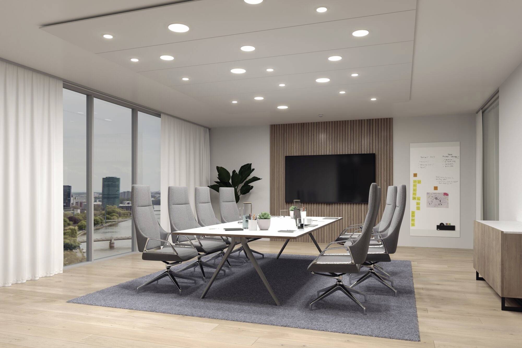 Salle de conférence avec une grande table, entourée de chaises modernes. Un écran mural et des fenêtres offrent une vue sur les bâtiments de la ville.