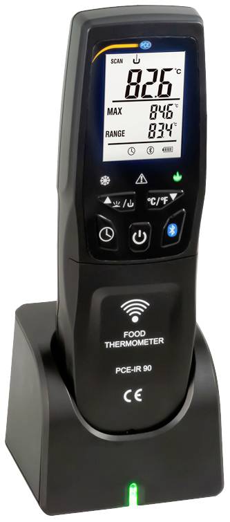 Un dispositif de mesure de température infrarouge numérique avec un grand écran affiche 82,6°C. Il est placé sur sa station de charge et offre une fonction Wi-Fi.