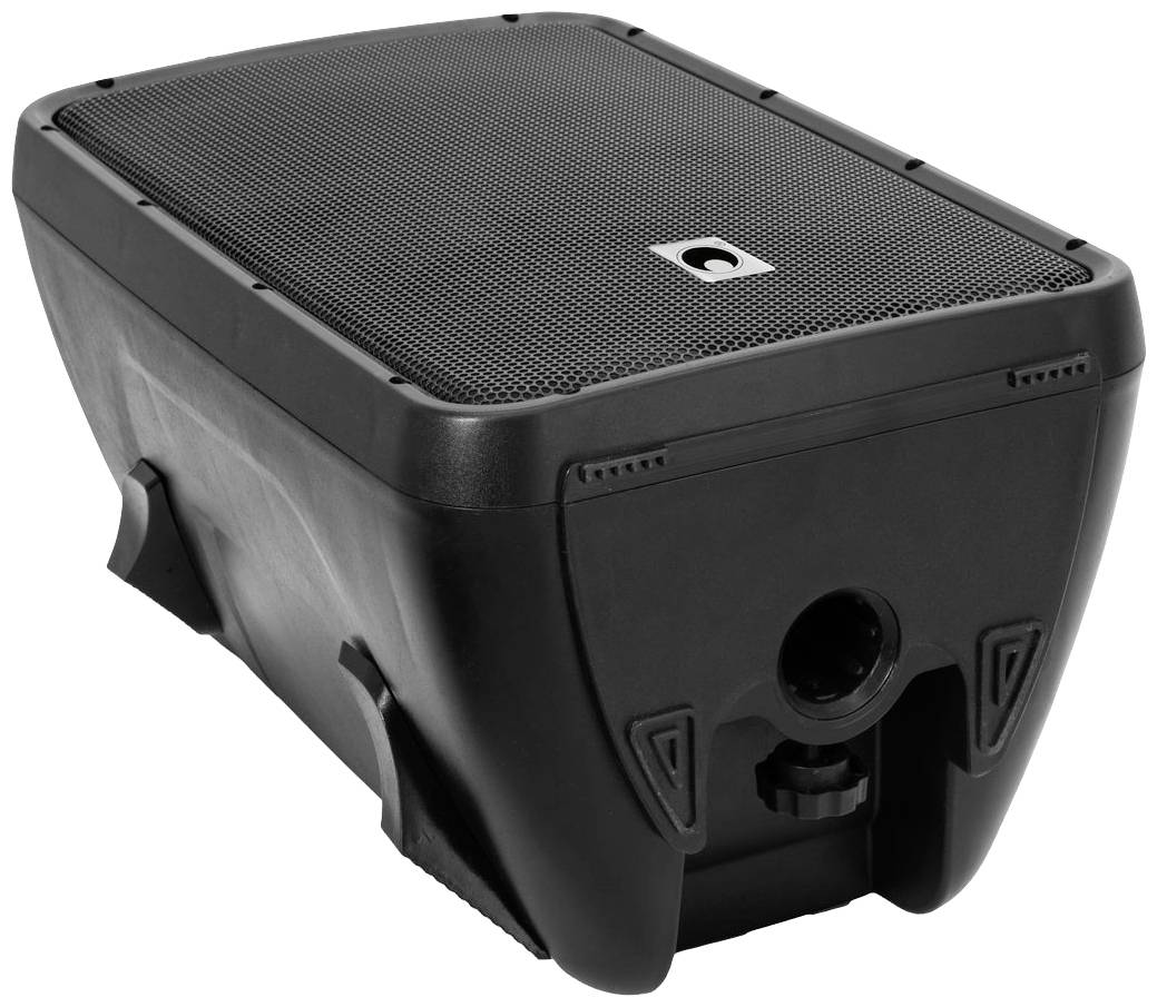 Haut-parleur noir rectangulaire avec un logo ponctuel en haut. L'appareil est incliné et montre le devant avec la prise de connexion.