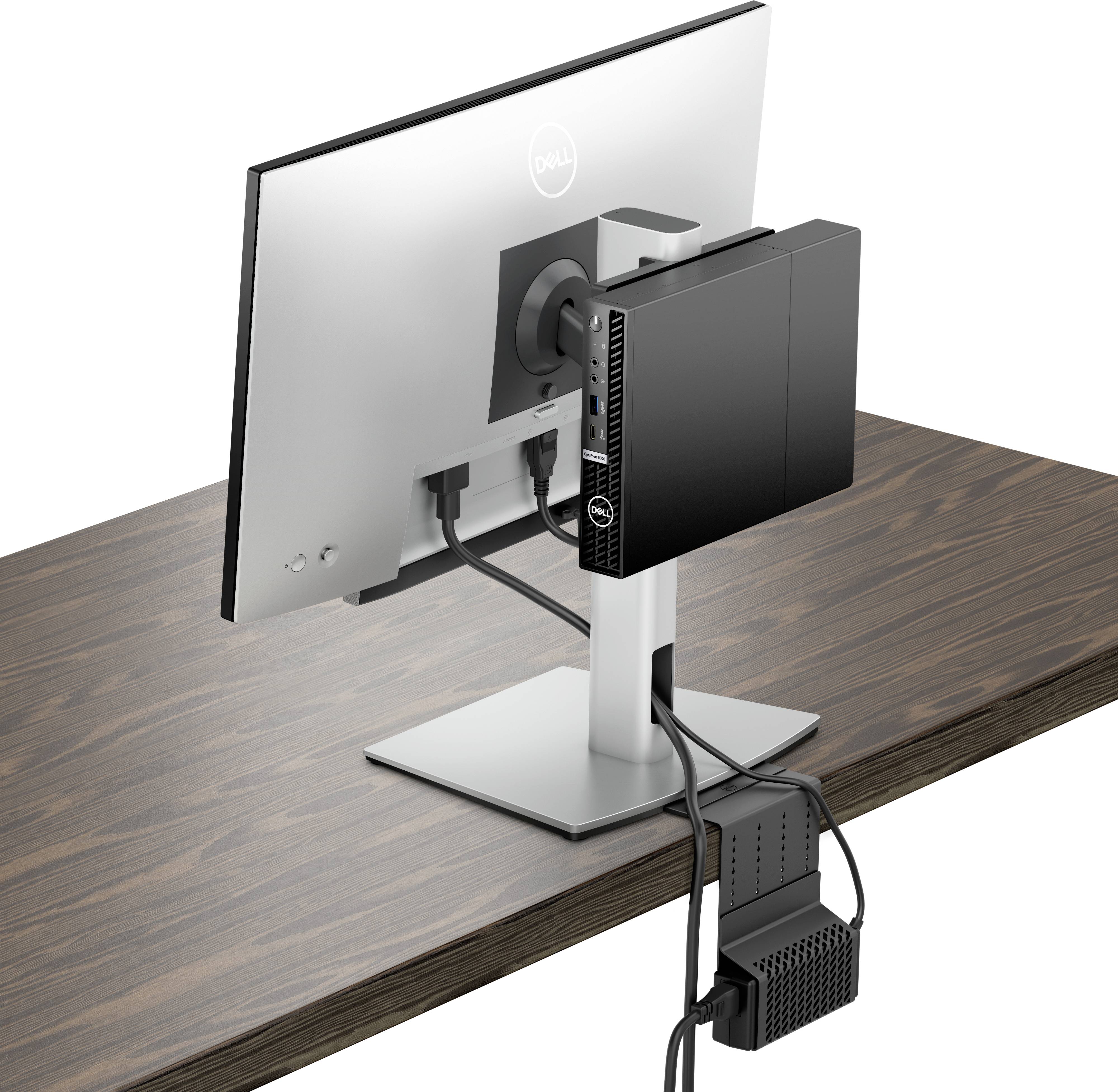 Un moniteur connecté à un mini-PC est monté à l'arrière d'un bureau en bois. Les câbles sont soigneusement organisés.