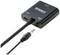 Convertisseur audio noir avec connexions USB et audio, relié par un câble audio de 3,5 mm. Marqué 'Speaka Professional'.